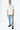 Pantalon Beleo Bleu Jean porté en pied de face par un mannequin homme, fleurs de lys noires, avec baskets noires