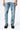 Pantalon Beleo Bleu Jean, gros plan de face sur les jambes, fleurs de lys noires brodées sur le denim clair