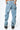 Pantalon Beleo Bleu Jean vu de dos, deux poches arrière et fleurs de lys noires brodées sur le denim clair