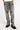 Pantalon Beleo Gris, gros plan de face sur les jambes, denim gris délavé, fleurs de lys noires et baskets noires