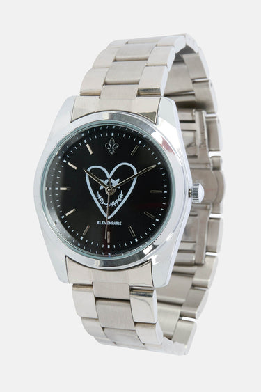 Montre Elad Noir vue de trois quarts, bracelet acier à maillons et cadran noir orné d'un coeur blanc