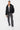 Blouson Eschott Noir porté en pied de face par un mannequin homme, pantalon cargo gris et baskets blanches