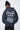 Sweat à capuche Evy Noir Délavé porté de dos par un mannequin homme, bonnet noir, grand cœur gris et Love Amor