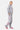 Jogging Jill Gris Chiné porté de profil par une mannequin femme, trois cœurs smiley sur la jambe, baskets roses