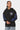 Sweat à capuche Fabian Noir porté de face par une mannequin femme, logo ELVN PRS et manches imprimées bleu