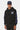 Sweat à capuche Fabian Noir porté de face par un mannequin homme coiffé d'une casquette bleu marine, logo ELVN PRS