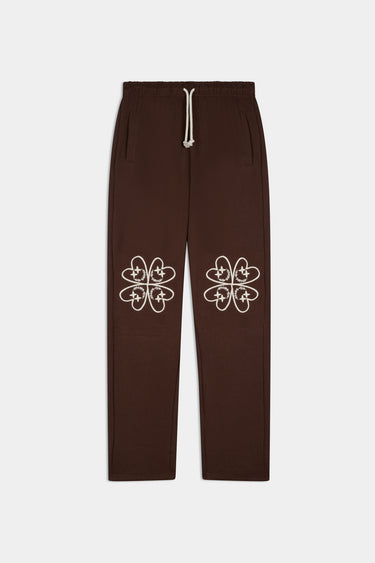Jogging Fallone Marron de face à plat, cordon crème et broderies de trèfles crème aux genoux