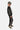 Jogging Fiston Noir vu de profil sur enfant, inscription verticale ELVNPRS blanche sur la jambe, casquette kaki