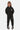 Jogging Frantz Noir porté en pied par un enfant, smiley fleur en strass sur la cuisse, baskets noires et blanches