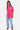 T-shirt Feremy Rose porté en pied par une femme, vue de face, petit cœur sur la poitrine, jean clair à fleurs de lys