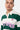 T-shirt polo rayé Feva Vert en gros plan sur un homme, col blanc, inscription ELVNPRS rose et petit cœur