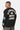 Sweat col rond Fifty Noir porté de dos et de profil par un mannequin homme, inscription Eleven Paris No Snitch Lovers