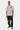 T-shirt Flaris Blanc porté de face par un mannequin homme, inscription l'amour win, pantalon noir à motifs fleur
