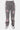 Pantalon Flex Gris porté de face par un mannequin homme, denim gris orné de fleurs de lys roses et blanches, baskets