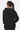 Sweat à capuche Flocon Noir porté de dos par une mannequin femme, capuche à bordure surpiquée blanche, uni