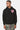 Sweat à capuche Fontenay Noir porté par un homme, de face, coeur rose brodé et pantalon camouflage