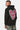 Sweat à capuche Fontenay Noir porté de dos par un homme, grand coeur rose en mosaïque et pantalon camouflage