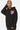 Sweat à capuche Fontenay Noir porté par une femme, de face, coeur rose brodé à yeux en croix sur la poitrine