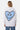 Sweat à capuche Fontenay Gris Chiné porté de dos par une femme, grand coeur bleu en mosaïque, jean bleu