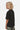 T-shirt enfant Forever Noir porté de profil, col rond et manches courtes, pantalon camouflage