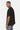 T-shirt Foufou Noir porté de profil par un homme, manches courtes oversize et surpiqûres grises