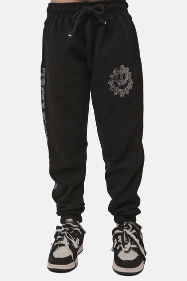 Jogging Frantz Noir porté par un enfant, de face, fleur souriante en strass sur la cuisse et cordon de serrage