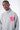 Pull col roulé Emile Gris chiné porté par un mannequin homme, gros plan buste et cœur rose brodé