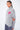 Pull col roulé Emile Gris chiné porté par une mannequin femme, vue de trois quarts avec cœur rose