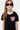 Robe enfant Jacky Noir en gros plan, cœur rose à paillettes au visage souriant sur la poitrine