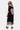 Robe enfant Jacky Noir vue de dos de trois quarts, cœur mosaïque rose et franges ornées de perles