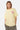 T-shirt Jais Jaune porté par une mannequin femme, de face, petit cœur rose sur la poitrine et jogging kaki