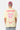 T-shirt Jais Jaune vu de dos sur un mannequin homme avec casquette bordeaux, cœur rose Eleven Paris