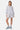 Short Jelissa Gris Chiné en molleton porté en pied par une mannequin femme, broderie Elevenparis sur la jambe