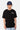 T-shirt Jamaica Noir porté de face par un mannequin homme, inscription Elevenparis blanche et casquette marine