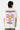 T-shirt Jamaica Écru vu de dos sur un mannequin homme, fleur rose et jaune souriante, texte Melrose Avenue