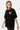 T-shirt Janiel Noir porté de profil par une mannequin femme, petit cœur zébré brun sur la poitrine