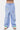 Pantalon Jasmin Bleu rayé large porté par un enfant, de face, soleil, coeur et arc-en-ciel brodés