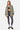 Veste Jaway Kaki portée ouverte par une mannequin femme en pied, avec brassière et legging cachemire noir et blanc