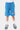 Short Jaxandre Bleu porté par un enfant, de face, cordon rayé noir et blanc et coeur brodé sur la cuisse