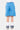 Short Jaxandre Bleu porté par un enfant, vue de dos, bas brut, chaussettes blanches et baskets bleu marine