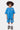 Short Jaxandre Bleu porté avec le t-shirt assorti par un enfant souriant, de face, coeur brodé sur la cuisse