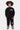 Jogging Jazzy Noir porté avec le sweat assorti par un enfant en pied, étoiles violettes sur les jambes et inscription rose