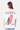 T-shirt Jerry Blanc porté par une mannequin femme, vue de dos, glace rouge No Snitch et inscription Eleven