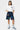 Short cargo Jolan Denim Bleu porté par une mannequin femme avec t-shirt blanc à cœur, fleurs colorées, vue de face en pied