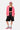 Sweat zippé à capuche Josalyne Rose porté par une mannequin femme avec short noir et casquette rose, vue de face en pied