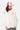 Sweat zippé à capuche Josie Écru porté par une mannequin femme avec casquette rose, fleurs sur les manches, vue de face