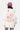 Sweat à capuche Josie Écru porté de dos par une mannequin femme, inscription Make Money et grandes fleurs pastel, casquette