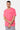 T-shirt Joums Rose porté par un mannequin homme, bras croisés, poche poitrine et broderie rouge Eleven, jogging gris