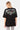 T-shirt Joy Noir oversize porté de dos par une mannequin femme, Parisian Tour No Snitch Live multicolore, legging zèbre