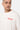 T-shirt Joy Écru porté par un mannequin homme, gros plan face, inscription rouge Parisian Tour No Snitch sur la poitrine
